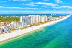 Aerial view of rows of condominium vacation rentals along the beach on Perdido Key, Florida in Pensacola shot from an altitude of about 500 feet during a helicopter photo flight.